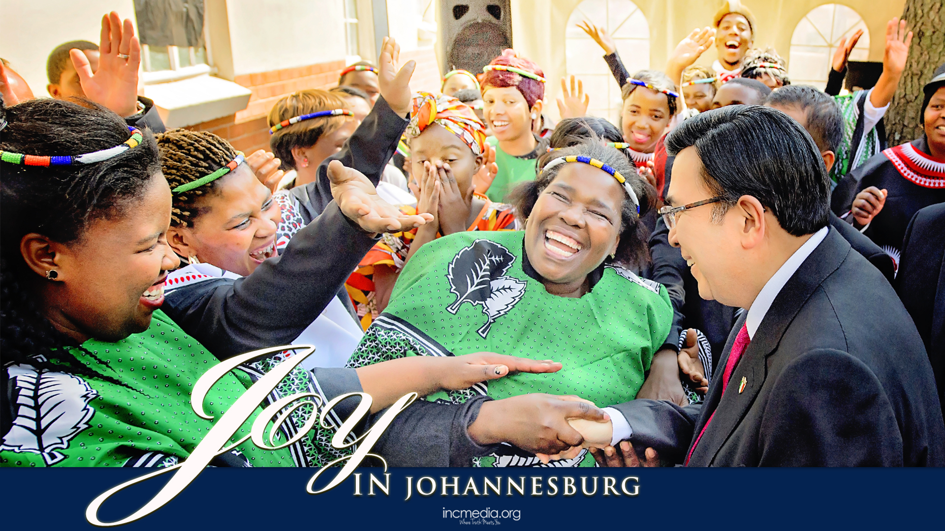 Crowd of Africans, smiling, shaking hands with Brother Eduardo V. Manalo (Executive Minister of the INC) with text overlay: Joy in Johannesburg