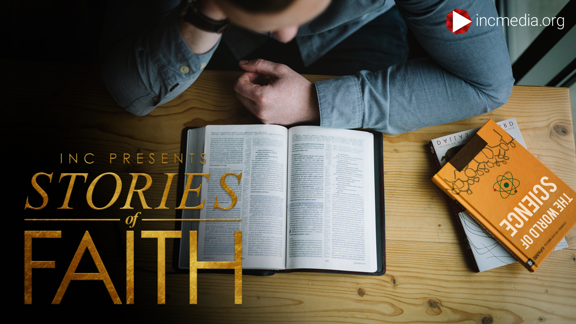 man reading the bible on a table with science books also on the table