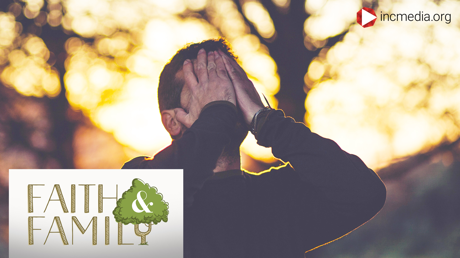 man covering his face with his hands