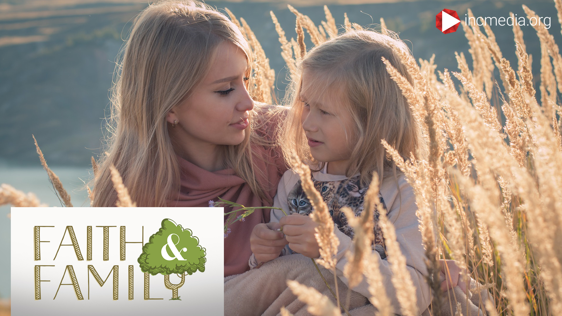 mother and daughter sitting together in a field