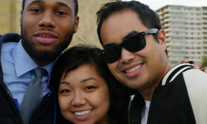two men and a woman smiling for a group picture