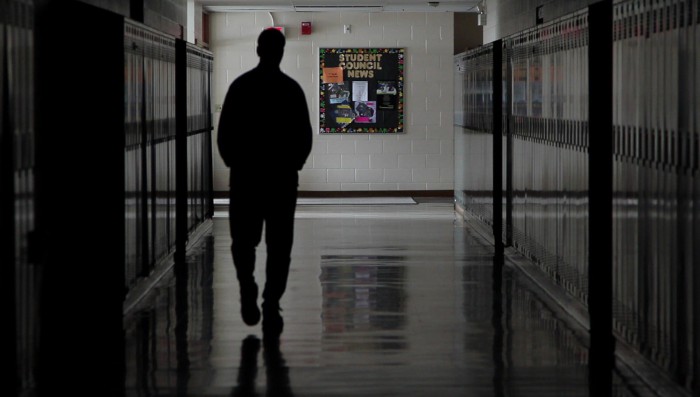 silhouette of man in school hallway