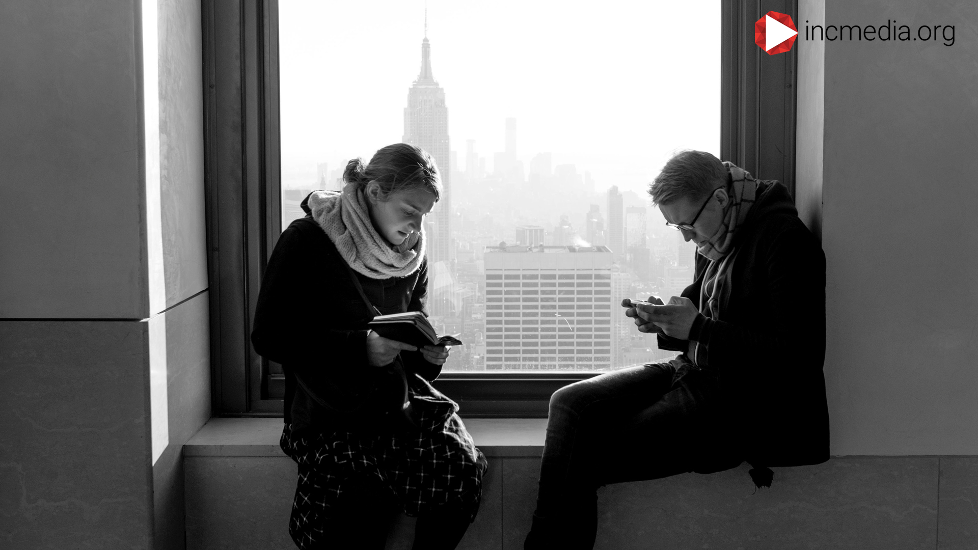 Two people at the window staring at their phones