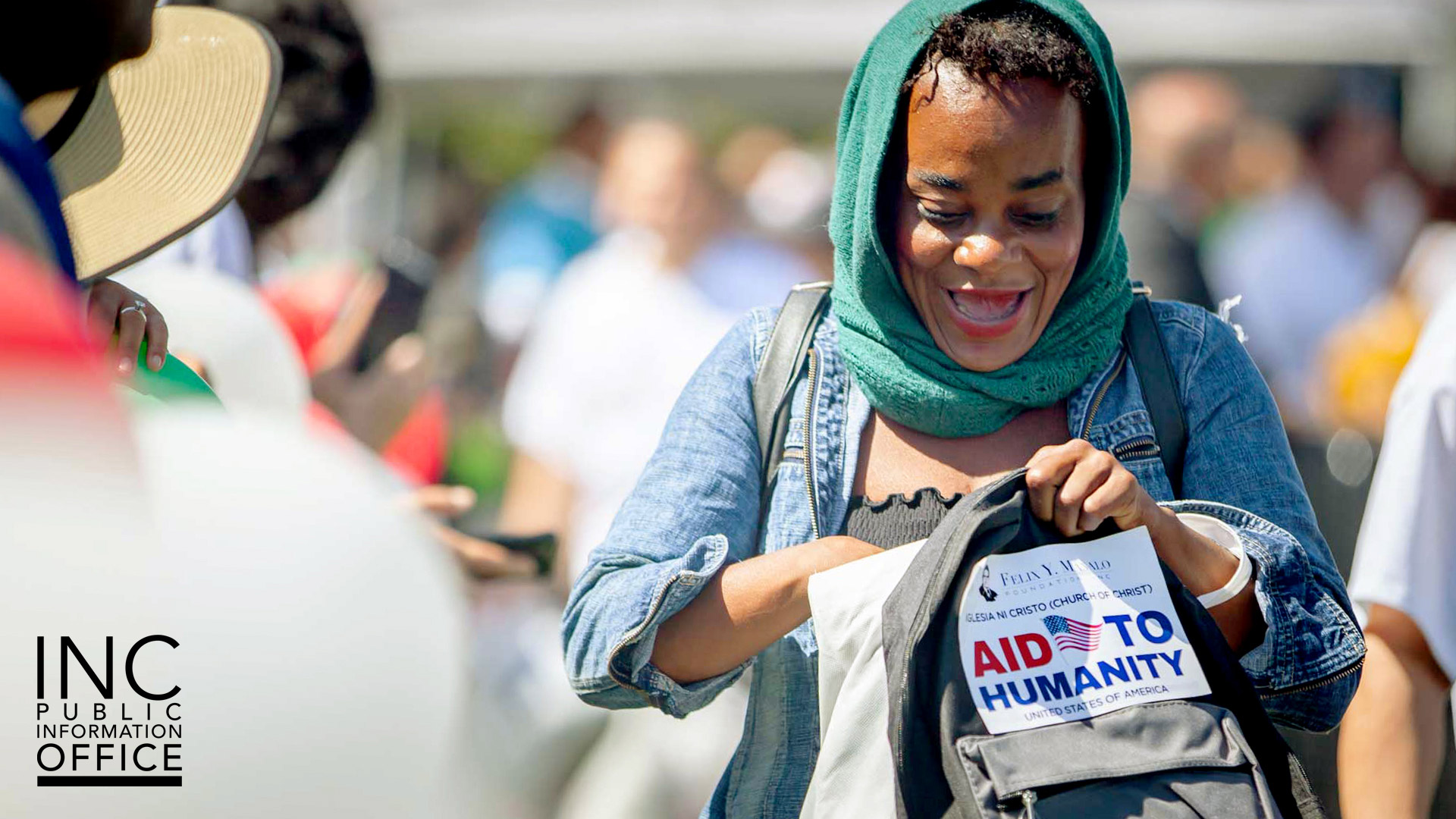 An Oakland resident is excited to see the care package contents at the Oakland Aid to Humanity event.