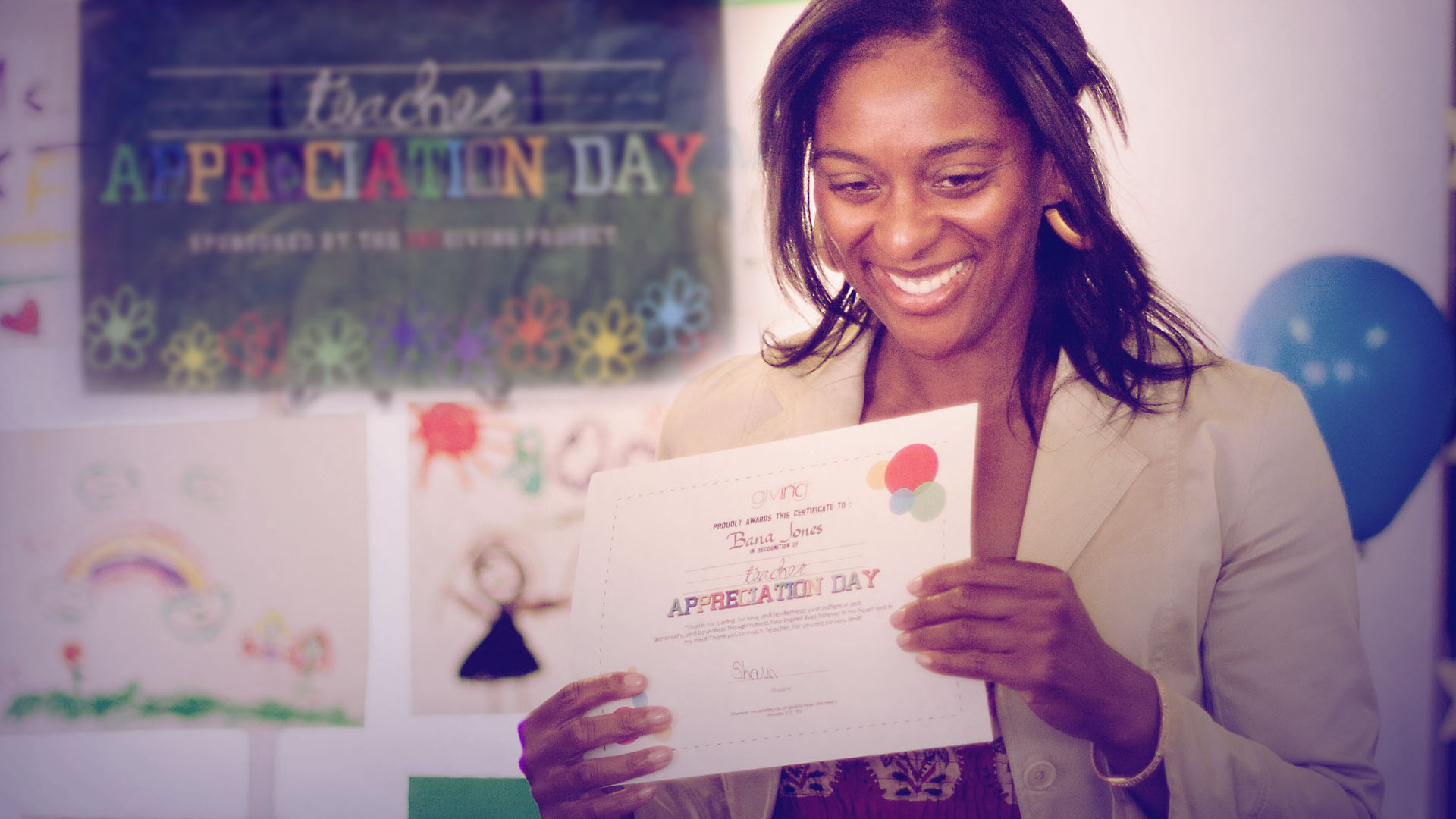 Woman holding a Teacher Appreciation Day Certificate smiling.