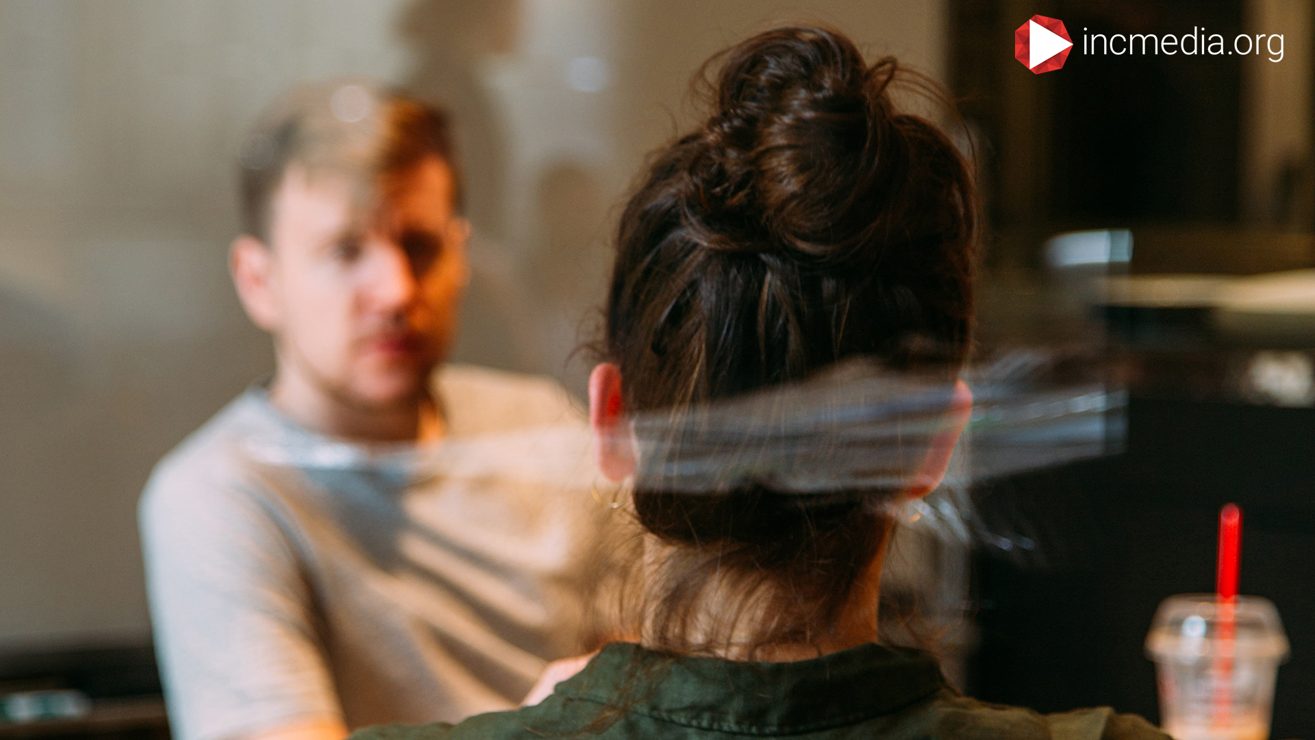 Man looking at a woman during a serious conversation.